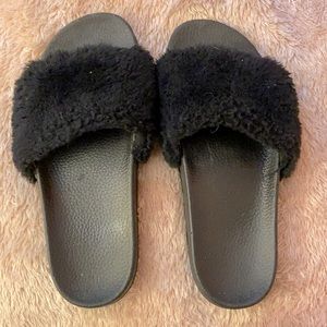 Pair of black fuzzy slippers